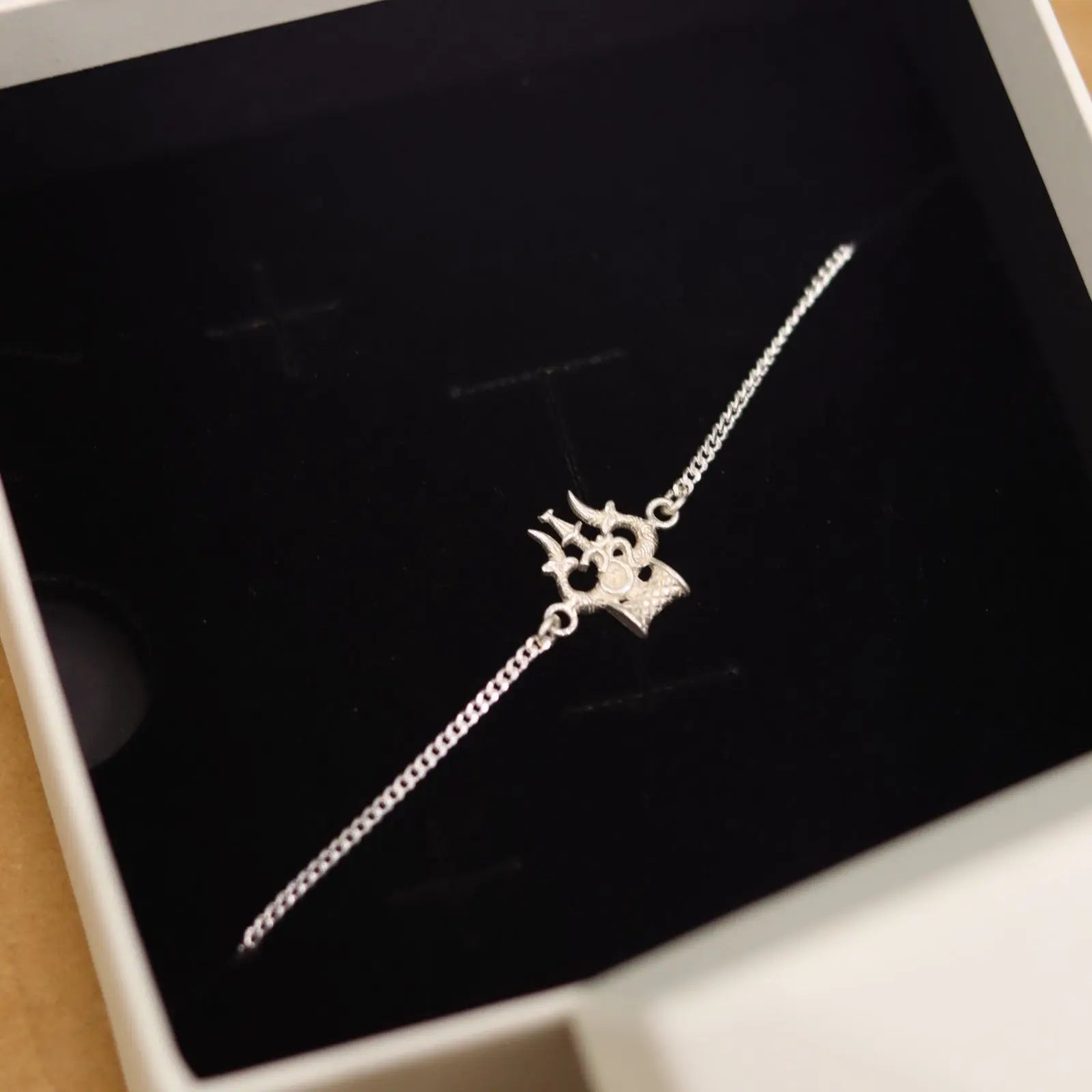 Silver bracelet with a unique design of trishul on a black background